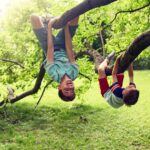 Kinder klettern lachend an Bäumen | ovaler Pool